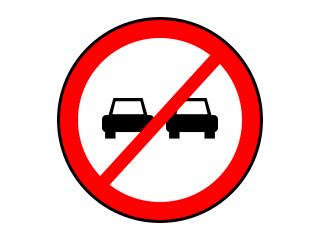 Red-bordered circle showing two cars and a red diagonal line